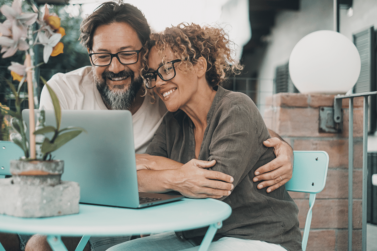 happy couple reading about opm processing times for disability retirement