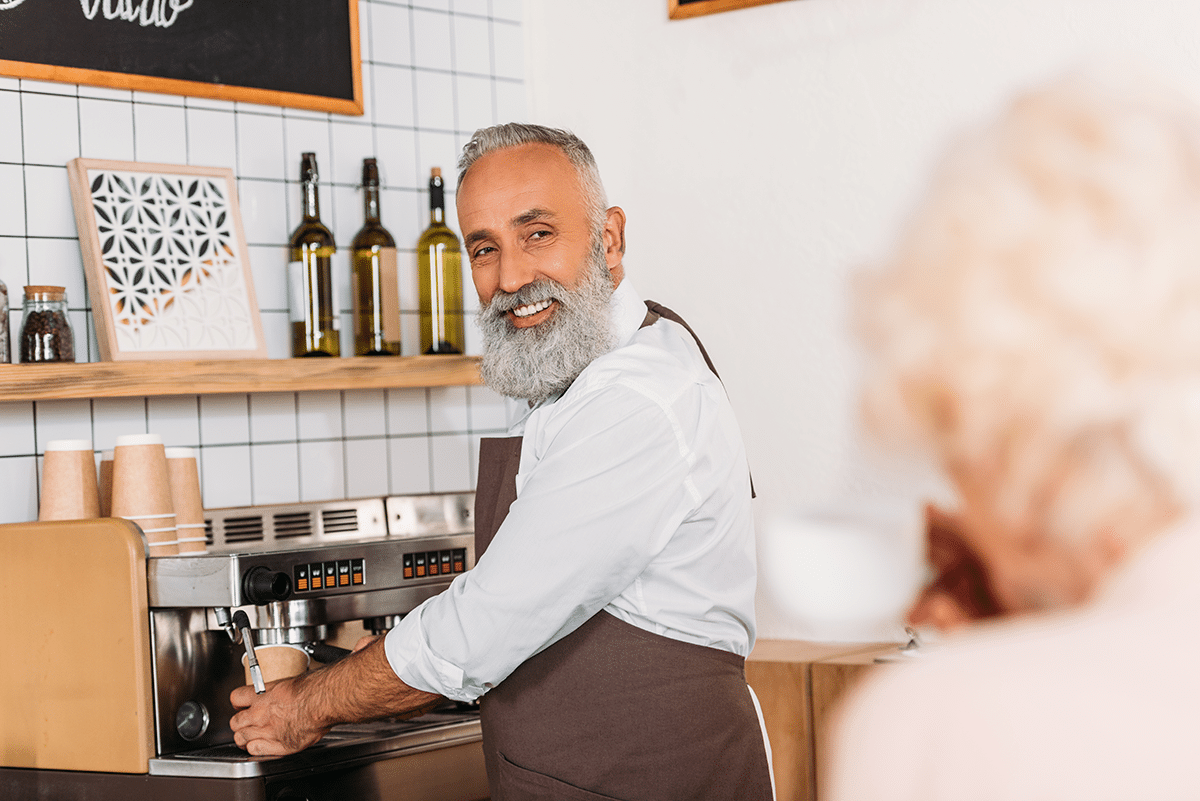 man earning income in the private sector working at a coffee shop