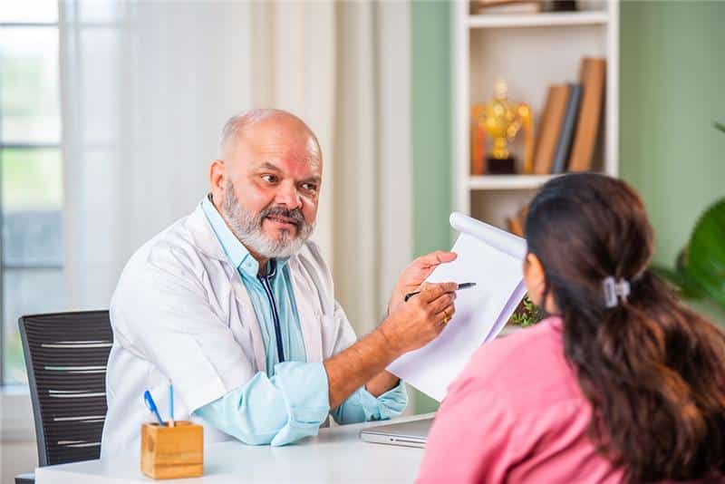 A doctor discussing a federal worker's medical conditions