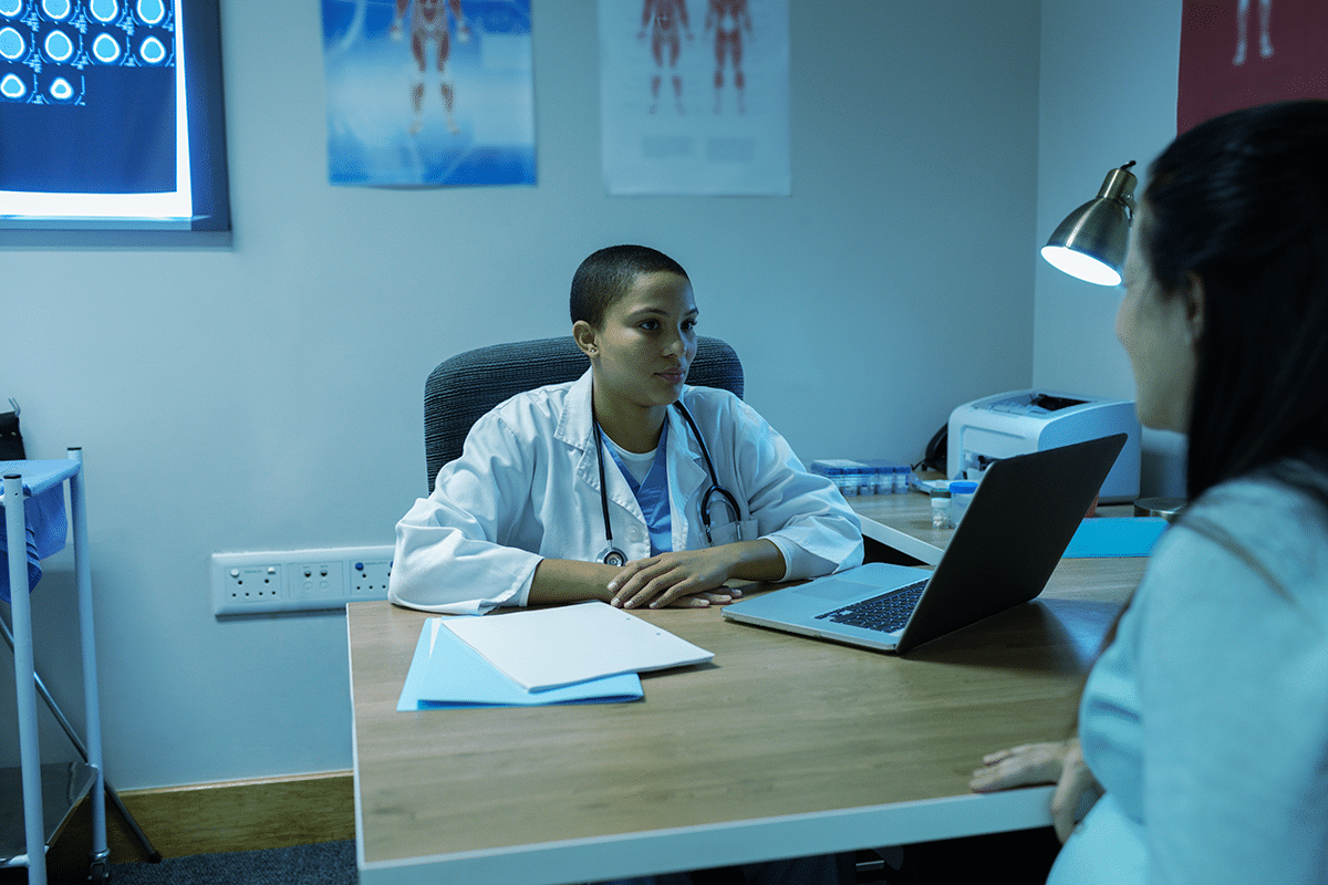 medical professional discussing treatment with patient health and life insurance coverage